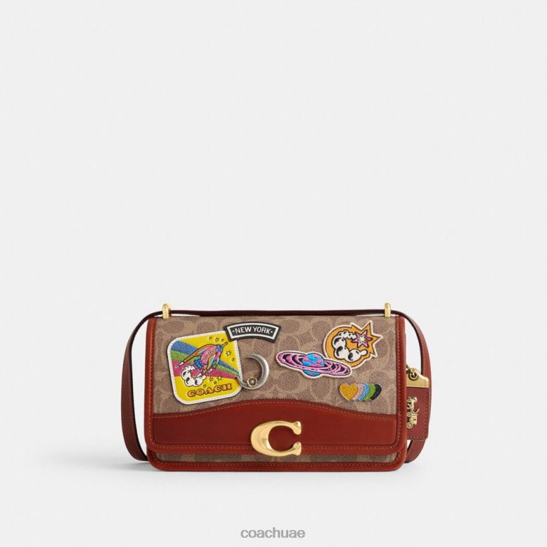 Coach نحيف حقيبة كتف كوزميك كوتش بانديت من القماش المميز مع رقع b4/صدأ أسمر متعدد 46266267